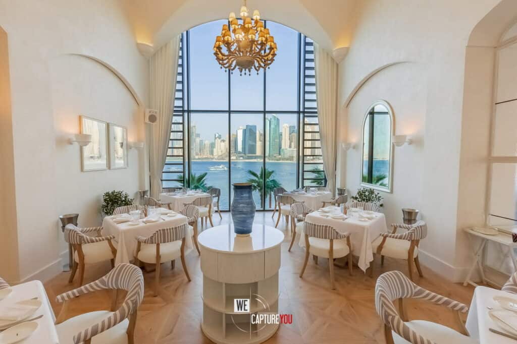 Luxurious dining area with large windows overlooking city skyline.