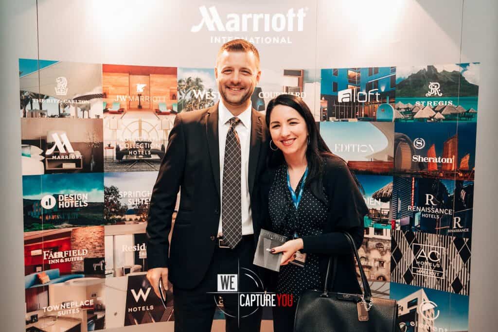Two smiling people at the Events and Awards 8, with Marriott International backdrop.