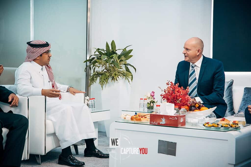 Business professionals in a meeting discussing strategies in a contemporary office setting.