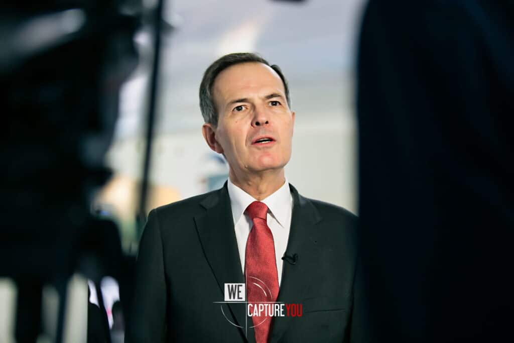 Business executive being interviewed in a professional setting.