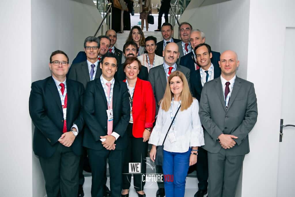 Group of diverse professionals at a corporate conference entrance.