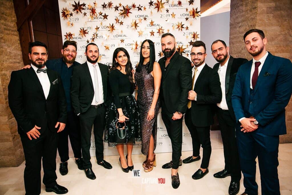 Group of professionally dressed people at a formal event with a star-themed backdrop.