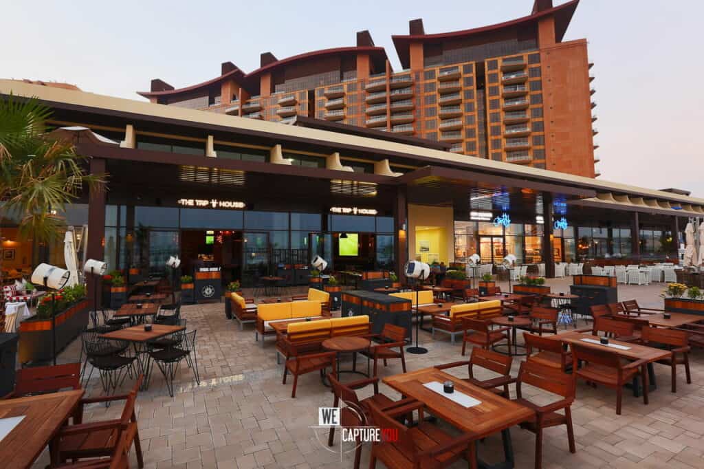 Outdoor restaurant seating with tables and chairs at WeCapture.