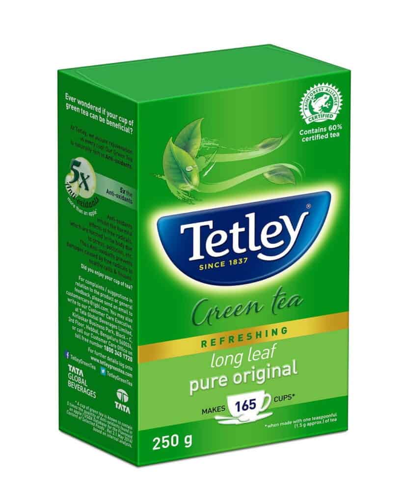 Tetley Green Tea box with green leaves and tea leaves illustration.