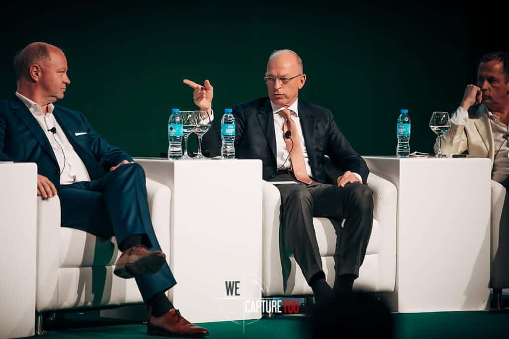 Panel of professionals discussing at a business conference.