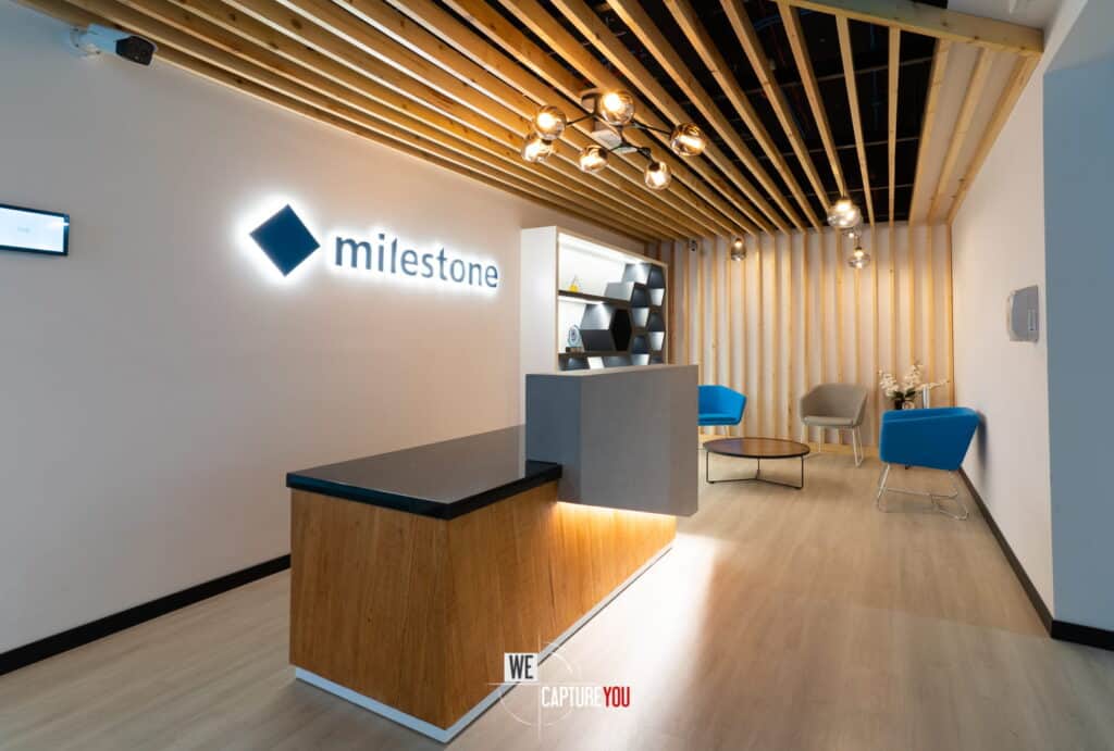 Modern office reception with Milestone logo and stylish seating.