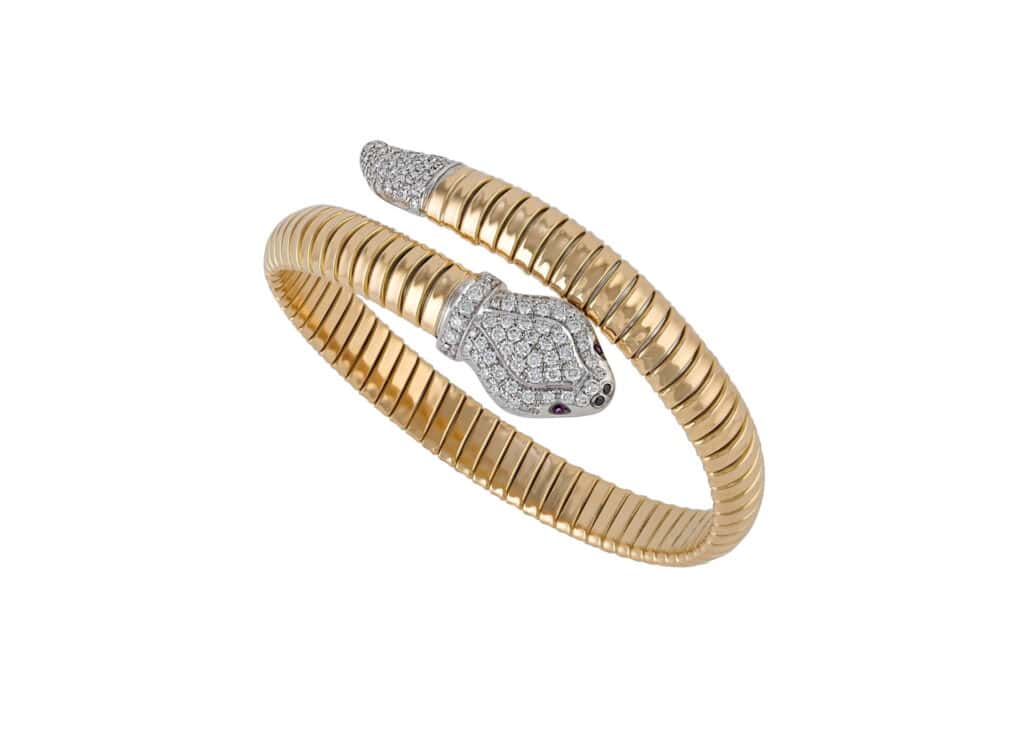 Elegant snake-shaped gold ring with diamond accents for women.
