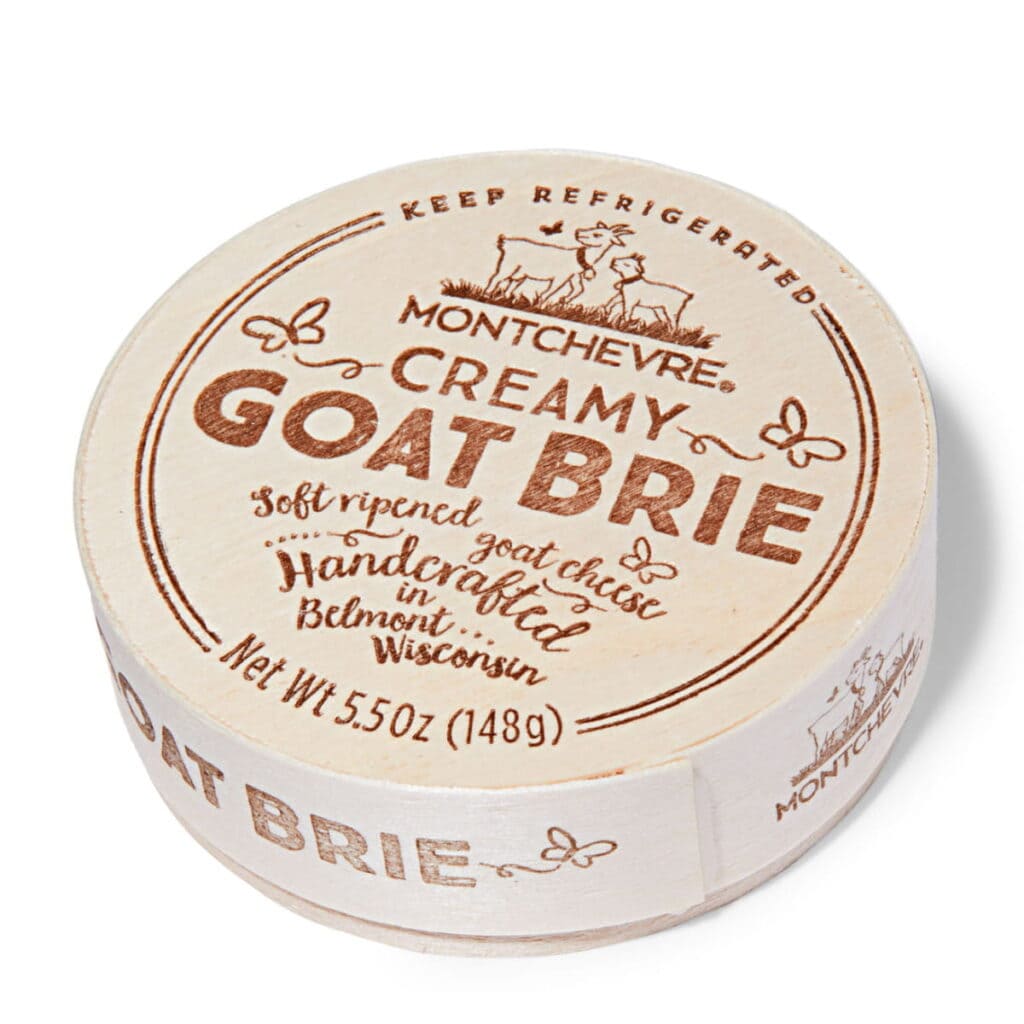 Montchevre creamy goat brie cheese in round packaging with vintage design.