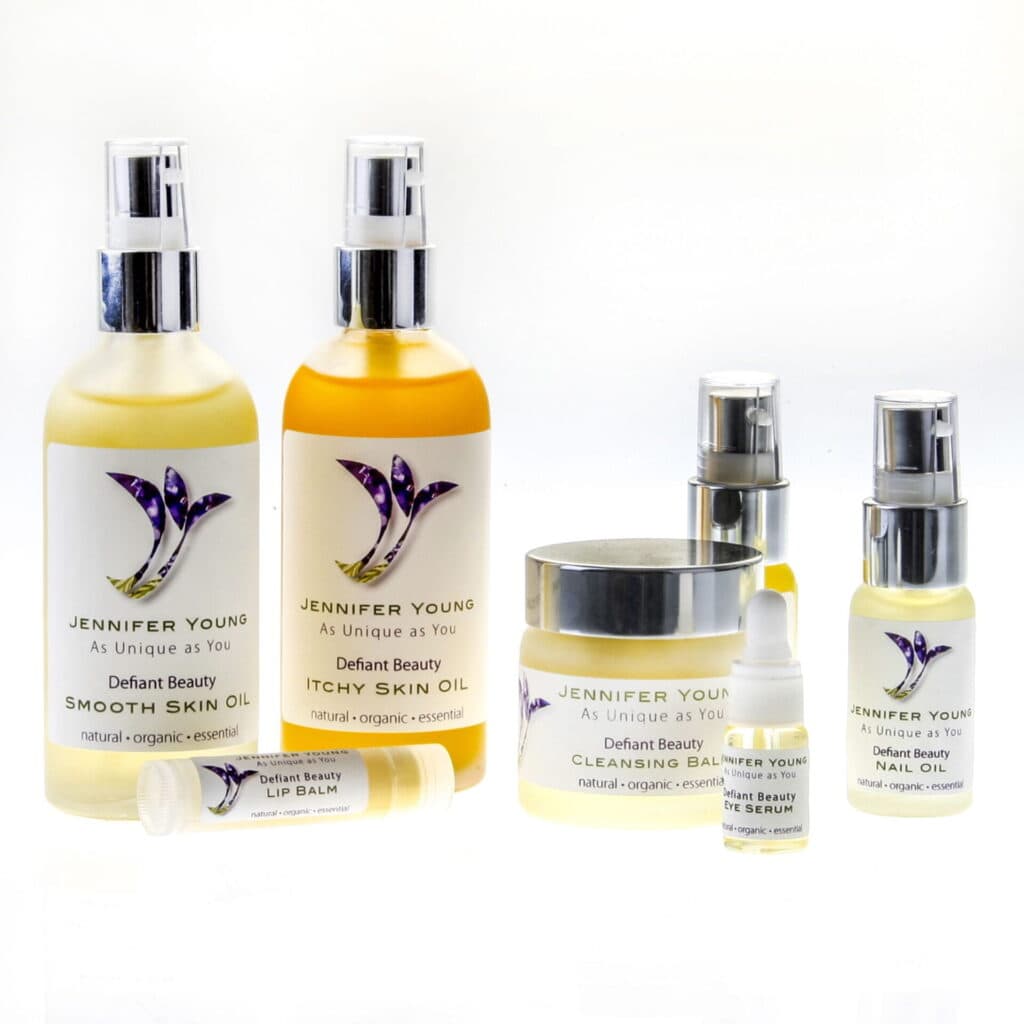 Skincare oil and balm bottles with pump dispensers and a lip balm container.