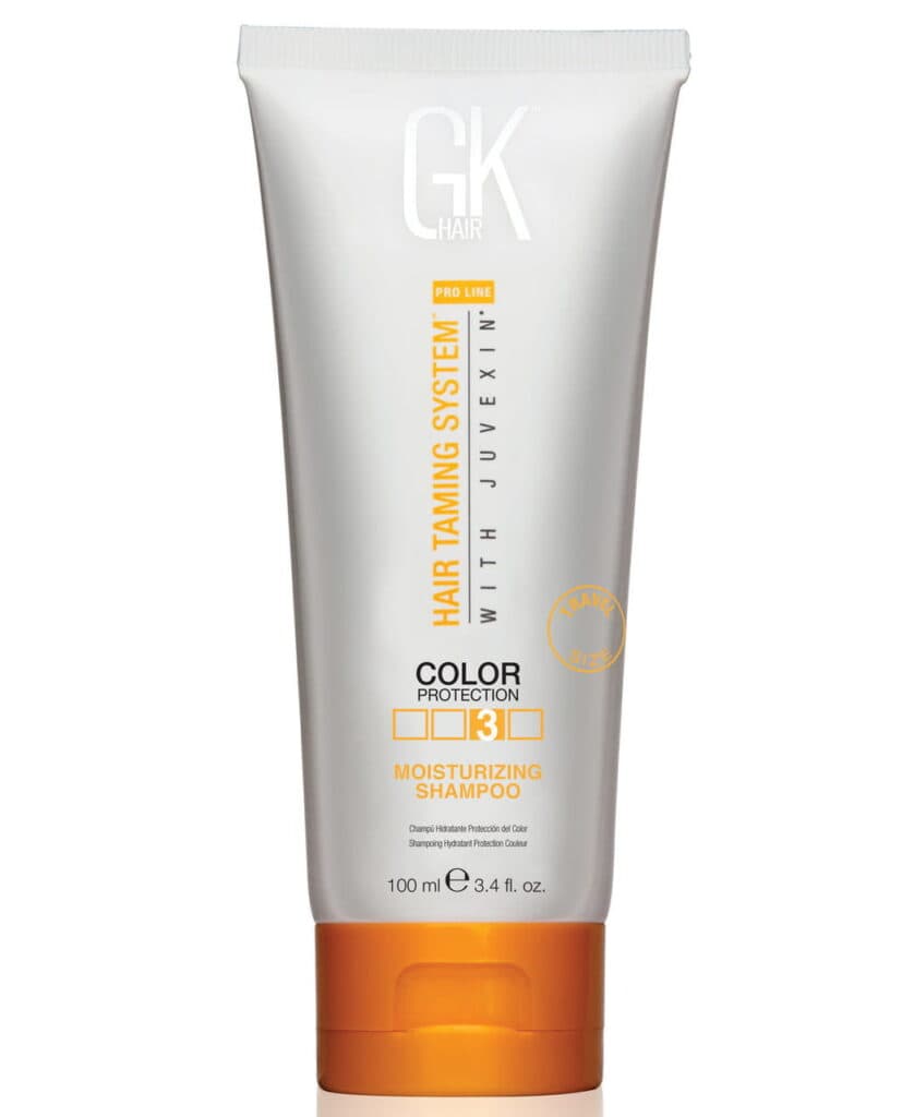 GK Hair moisturizing shampoo in white and orange tube for color protection and hydration.