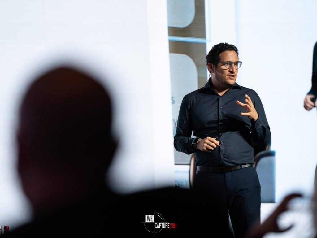 Man giving a business presentation in a modern conference room.