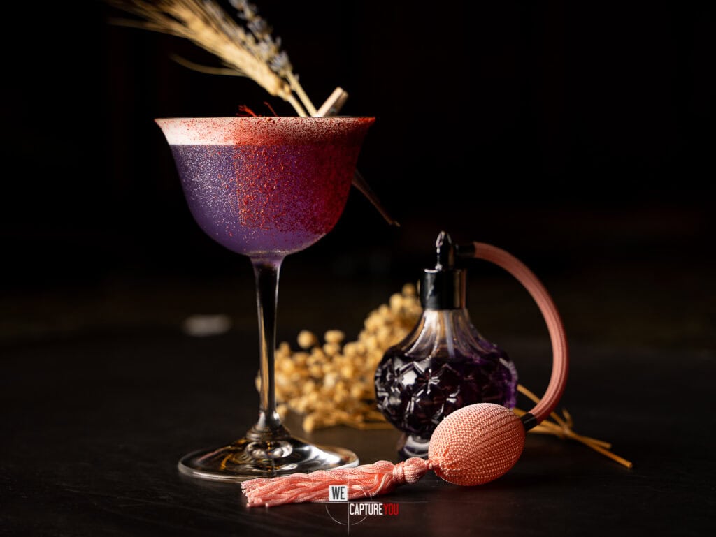 Stylish cocktail in a glass with decorative elements on a dark background.