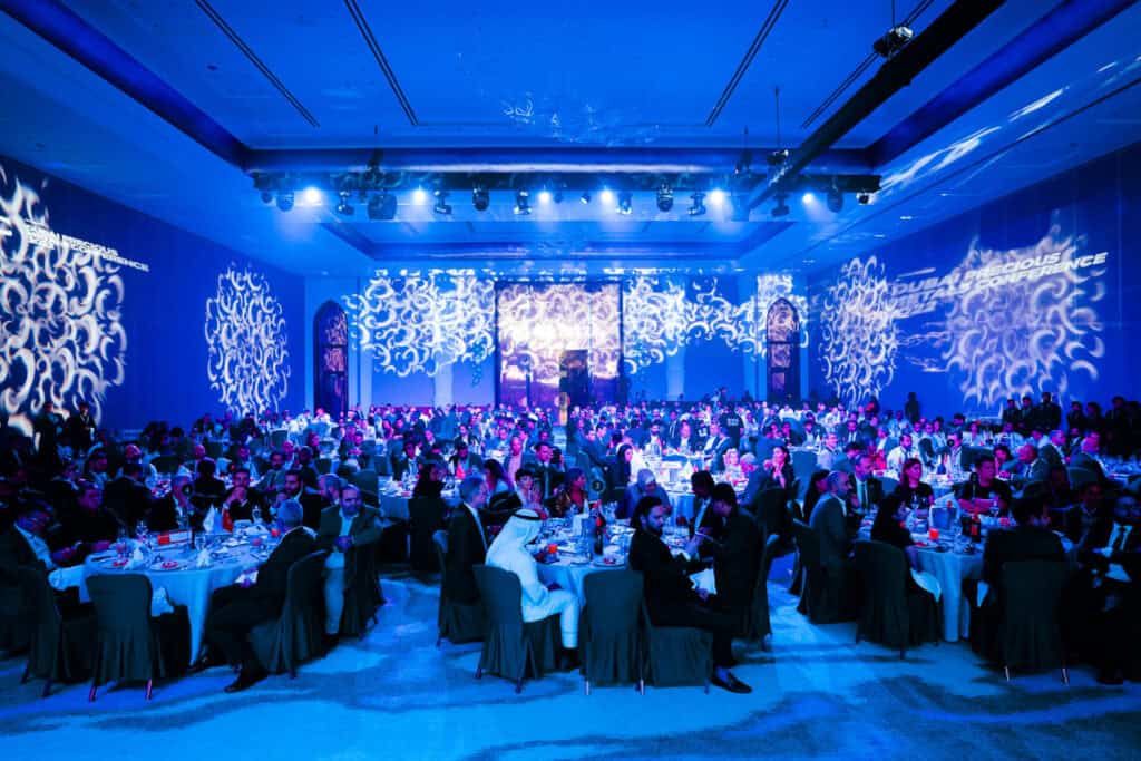 Large conference hall with attendees at DMCC Precious Metals event.