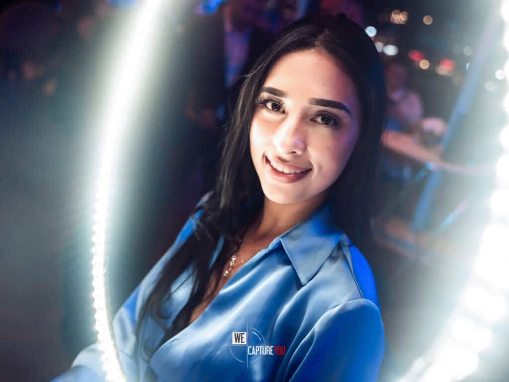 Young woman smiling at Dubai event, professional photography by WeCapture.