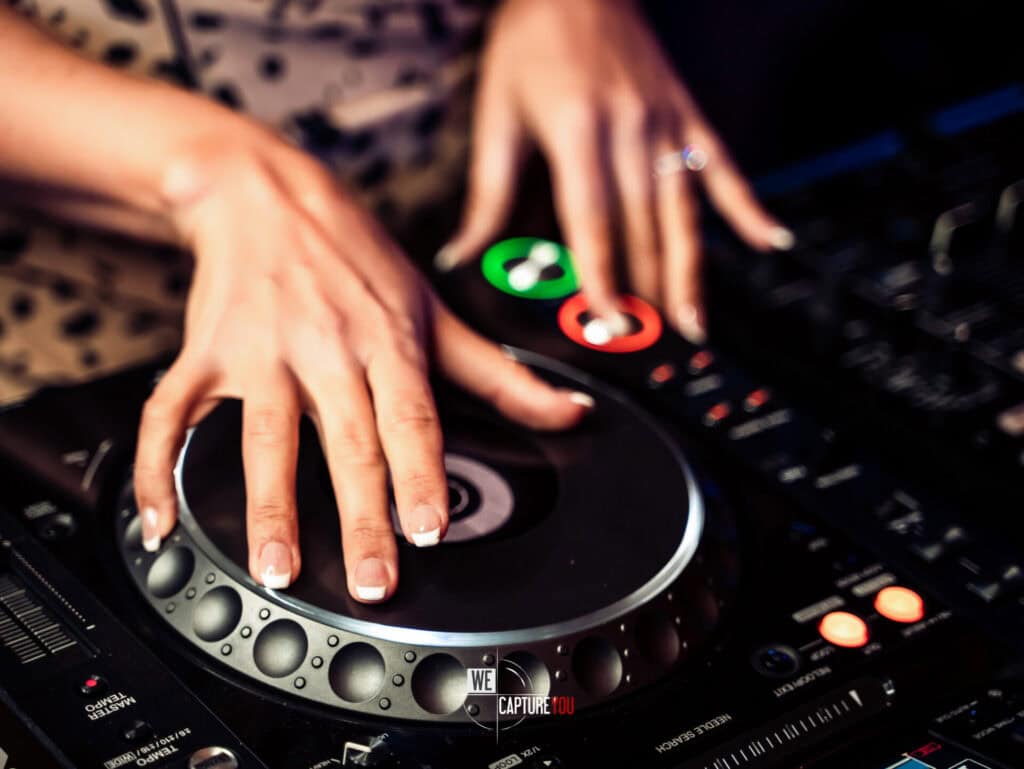 DJ mixing music at Dubai video production event with professional equipment.