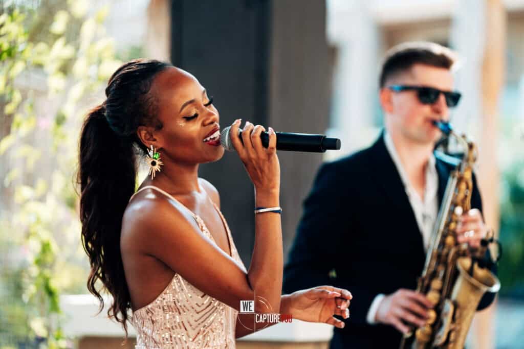 Jazz singer performing with saxophonist at Dubai Abu Dhabi event.