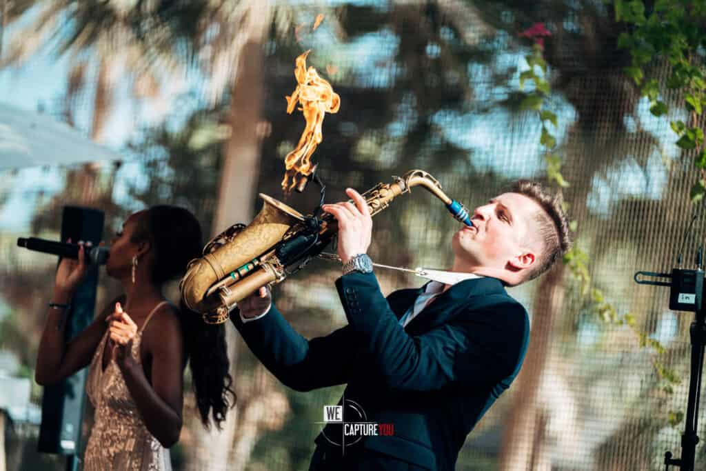 Male saxophonist playing saxophone at outdoor corporate event in Dubai.
