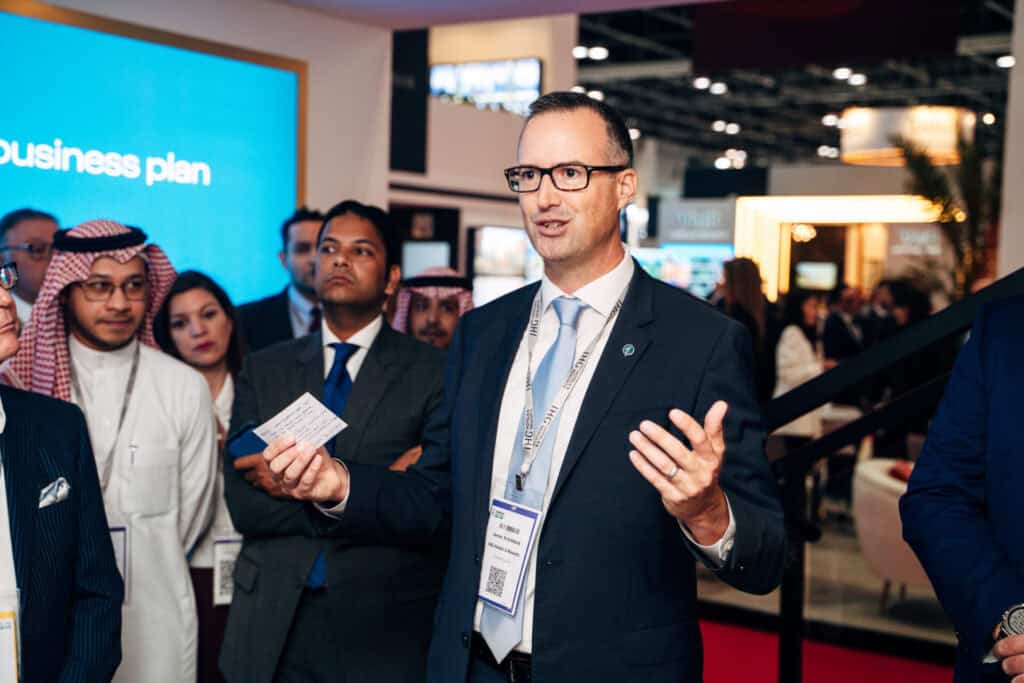 Man giving a business presentation to diverse audience at conference.