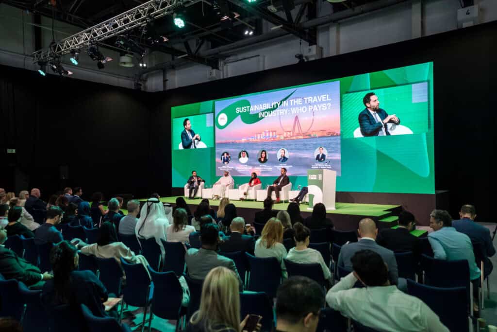 Panel discussion on sustainability in the travel industry at WeCapture event.