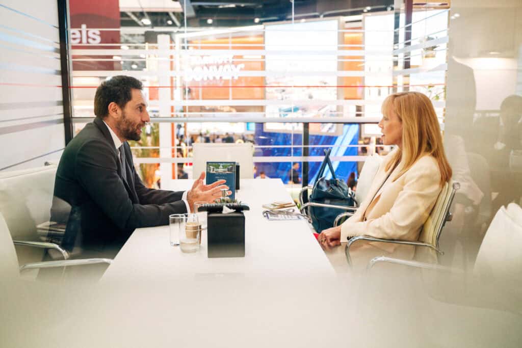 Professional business meeting between man and woman in modern office.