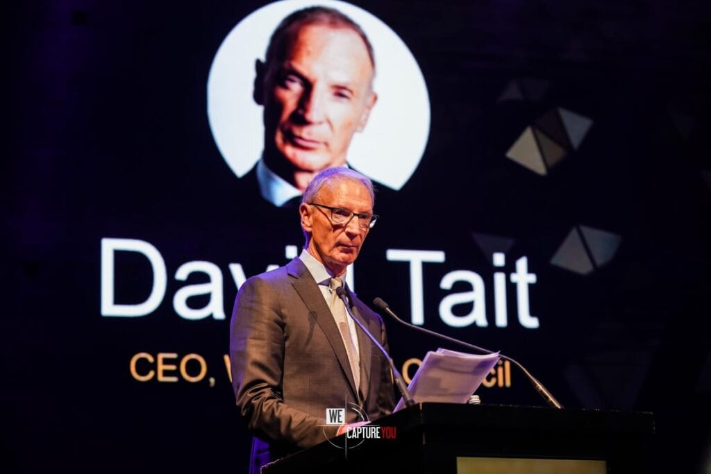 CEO David Tait delivering speech at corporate event in Dubai.