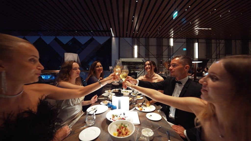 Business professionals celebrating at a formal dinner during Insead University Event 2024.