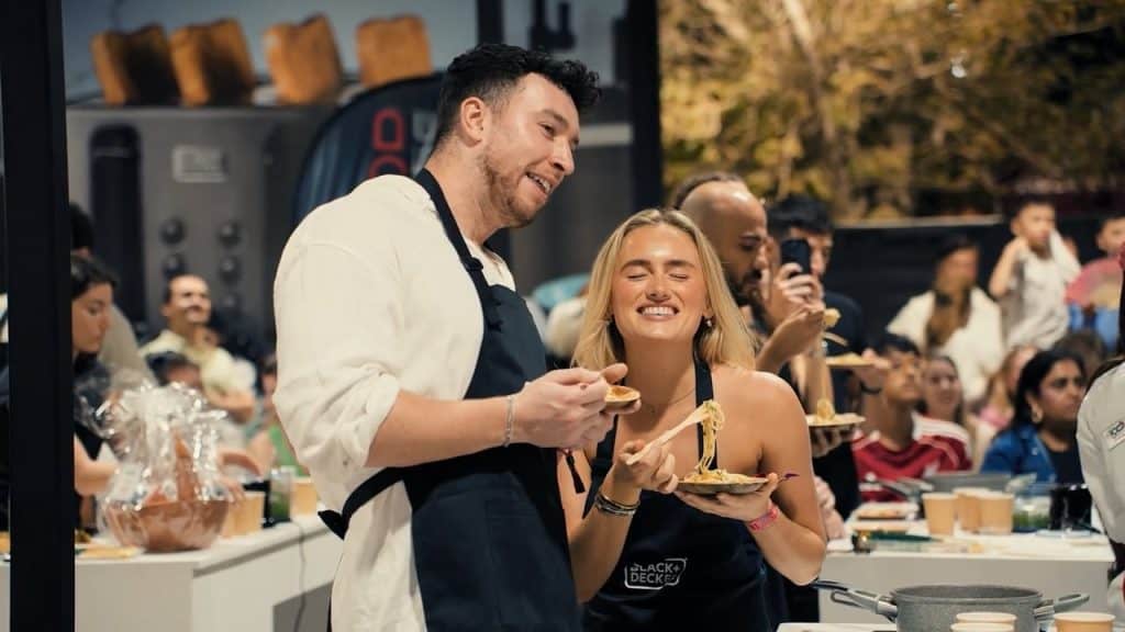 People enjoying food and drinks at Taste of Dubai 2026 event outdoors.